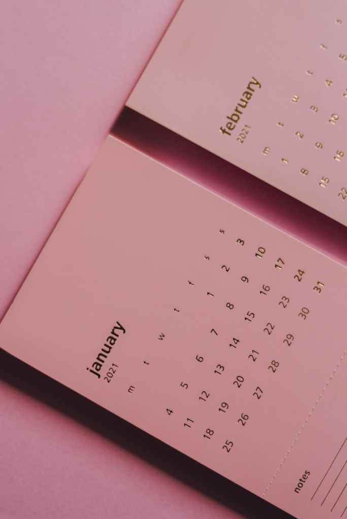 modern monthly calendar on table on pink background